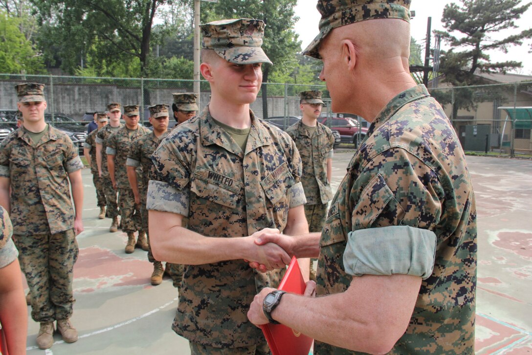 Lance Cpl. Marcus A. Whited (left), U.S. Marine Corps Forces Korea G6 help-desk clerk, is congratulated before receiving a Certificate of Commendation from Maj. Gen. Patrick J. Hermesmann, MARFORK commander, during a ceremony here, May 14. Whited was selected Marine of the Quarter for performing above his peers. (U.S. Marine Corps photo by Staff Sgt. Anthony Kirby/Released)
