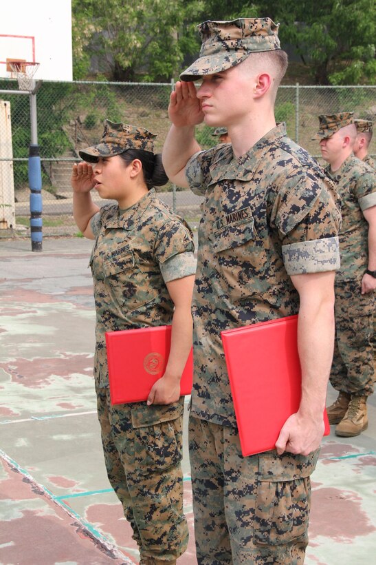 U.S. ARMY GARRISON, YONGSAN – Sgt. Norma Azgomez (left), U.S. Marine Corps Forces Korea G1 non-commissioned officer in charge, and Lance Cpl. Marcus A. Whited, MARFORK G6 help-desk clerk, salute after being recognized during a ceremony here, May 14. Both Marines received a Certificate of Commendation; Azgomez for being selected NCO of the Quarter, and Whited for being selected Marine of the Quarter. (U.S. Marine Corps photo by Staff Sgt. Anthony Kirby/Released)