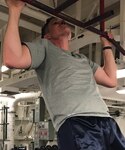Lieutenant David Williams, from Provo, Utah, does pull-ups on the Ticonderoga-class guided-missile cruiser USS Antietam (CG 54) as part of the “Murphy Challenge.”. Antietam is on patrol in the U.S. 7th Fleet area of operation supporting security and stability in the Indo-Pacific region.