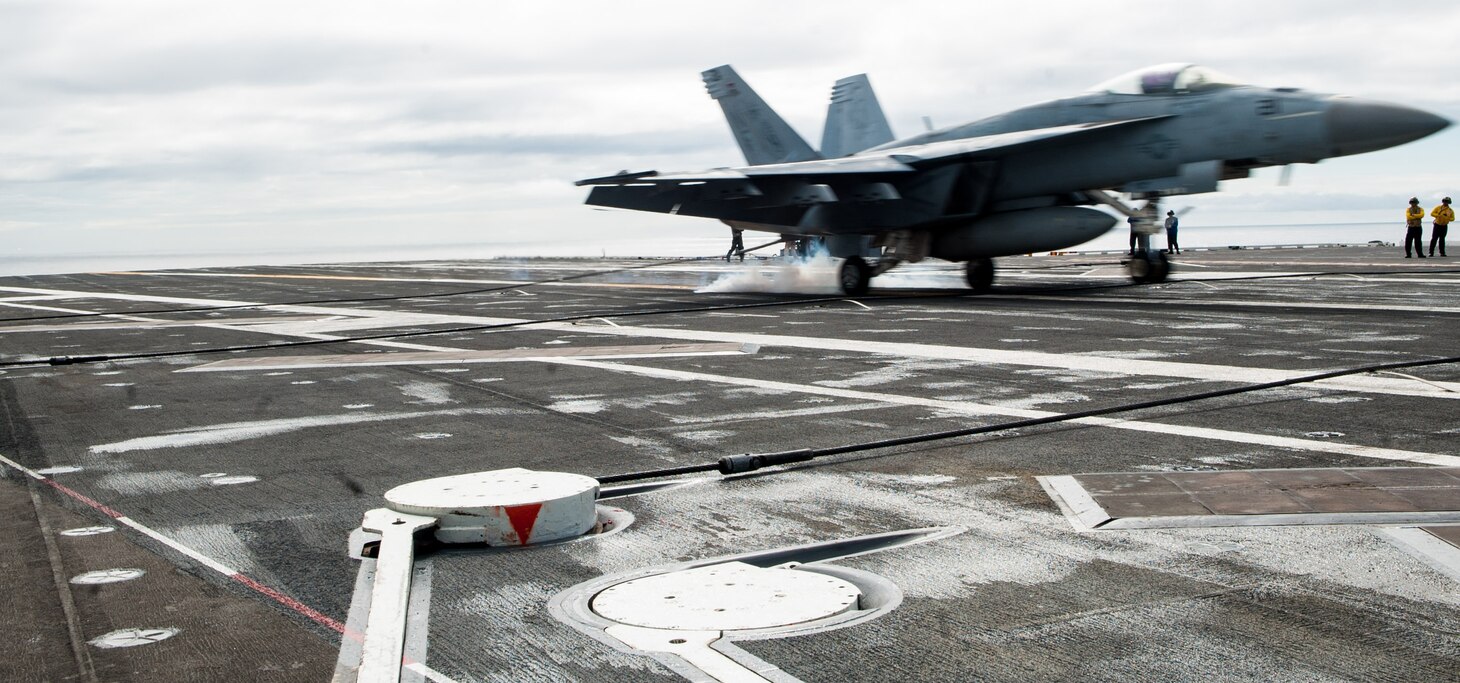 An F/A-18E Super Hornet, assigned to Strike Fighter Squadron (VFA) 27, lands on the flight deck during carrier qualifications with the Navy's forward-deployed aircraft carrier, USS Ronald Reagan (CVN 76), and Carrier Air Wing 5. Ronald Reagan, the flagship of Carrier Strike Group 5, provides a combat-ready force that protects and defends the collective maritime interests of its allies and partners in the Indo-Asia-Pacific region.