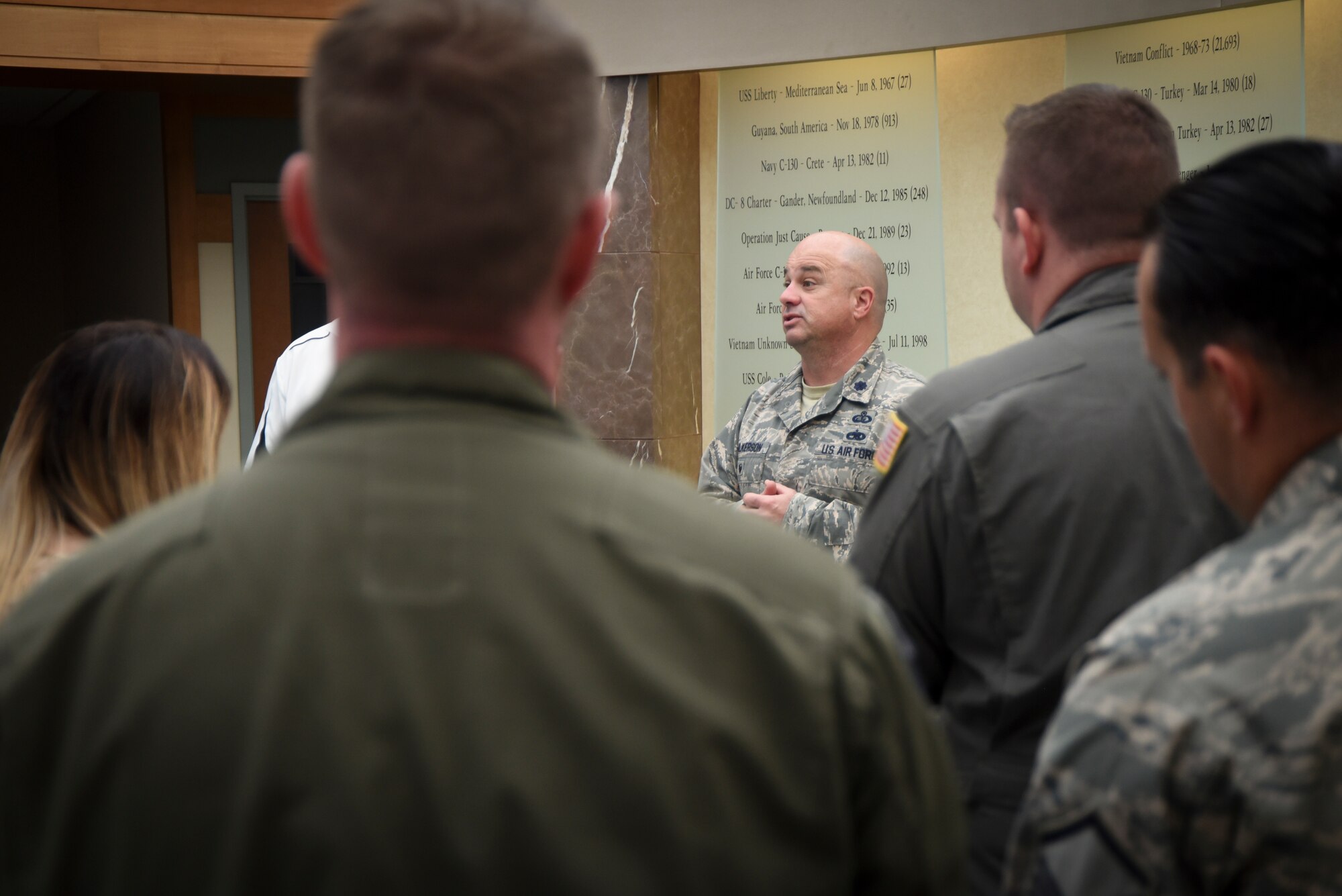 Col. Wilkerson speaks to Team Dover in front of memorial wall.