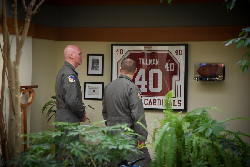 Team Dover members look at the Pat Tillman jersey on display at AFMAO.