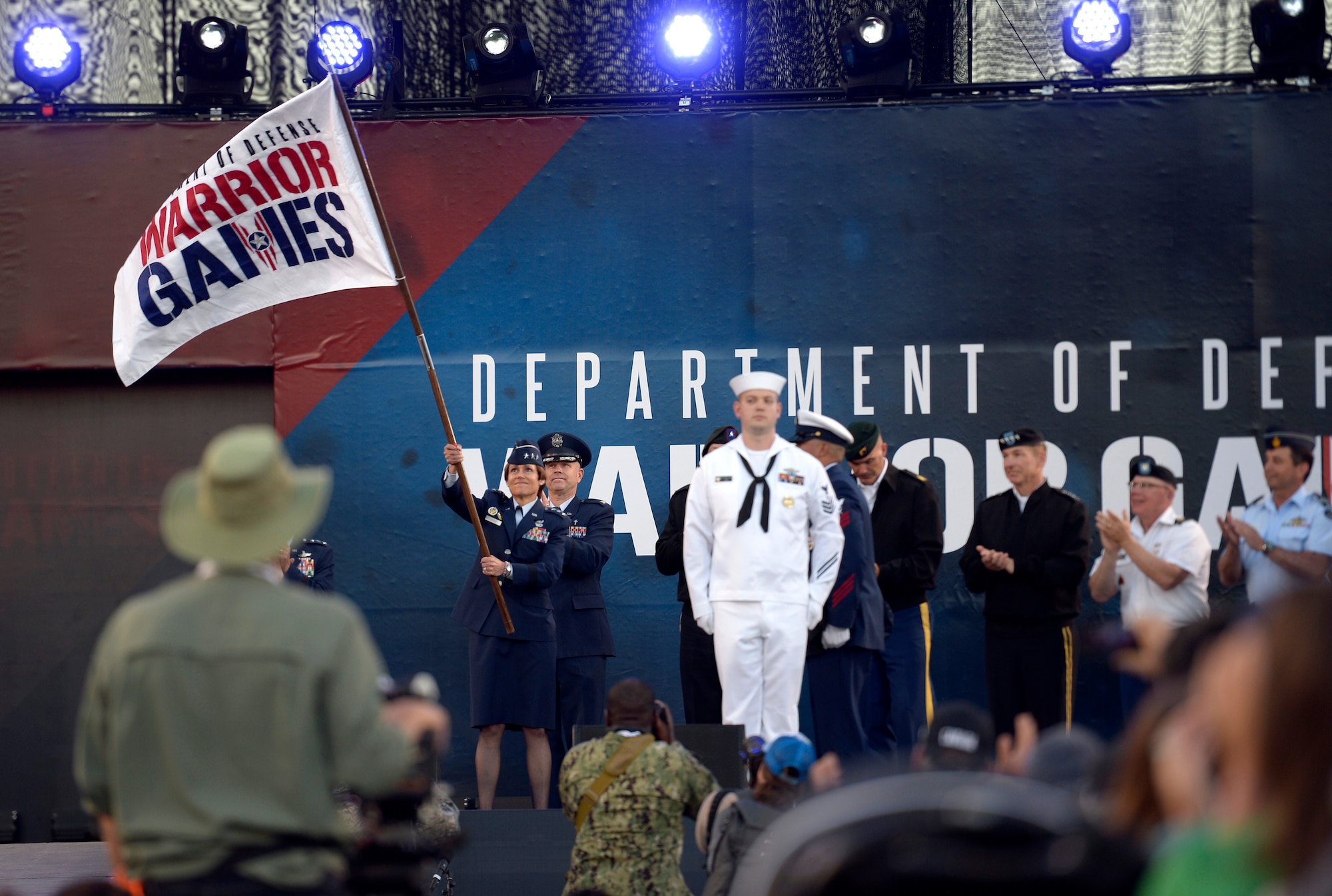 Lt. Gen. Gina M. Grosso, Deputy Chief of Staff for Manpower, Personnel and Services, waves the Department of Defense Warrior Games flag June 2, 2018, during the opening ceremony at the U.S. Air Force Academy's Falcon Stadium. First held in Colorado 
Springs in 2010, the Warrior Games were established as a way to expose service members who were wounded, ill or injured to adaptive sports. The Air Force is the host service for this year's Games. (U.S. Air Force photo by Tech Sgt. Anthony Nelson Jr.)