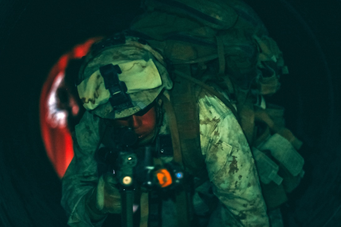 A Marine helps with an underground tunnel clearing.