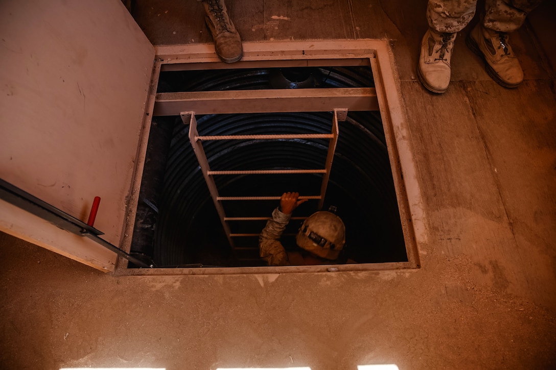 A Marine clears an underground tunnel.