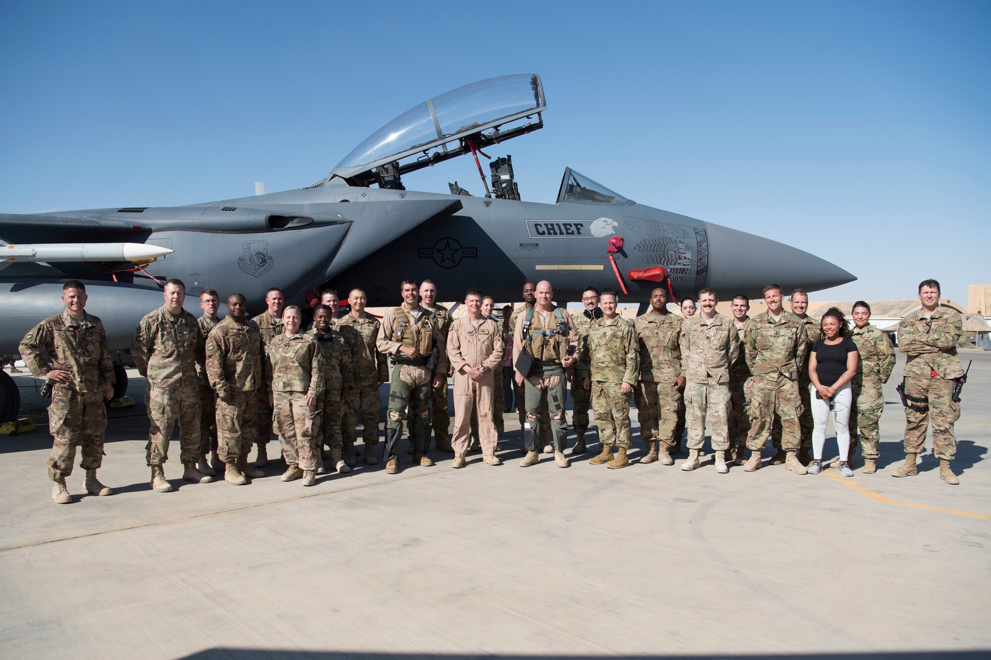 Members from the 332nd Air Expeditionary Wing pose for a group photo with Col. William Marshall, 332nd Expeditionary Operations Group commander, after his final flight here June 2, 2018