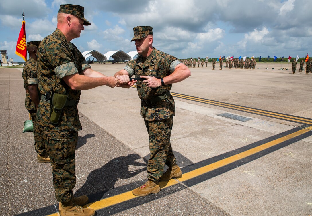 Brig. Gen. Bradley S. James, left, commander of 4th Marine Aircraft Wing, appoints Sgt. Maj. Thomas M. Burkhardt, right, as the new sergeant major of 4th MAW during a relief and appointment ceremony held at the Marine Light Attack Helicopter Squadron 773, Marine Aircraft Group 49, 4th MAW, airfield, New Orleans, June 2, 2018. Burkhardt is replacing Sgt. Maj. Rodney L. Lane, who served as the 4th MAW sergeant major from 2016-2018. (U.S. Marine Corps photo by Sgt. Melissa Martens)