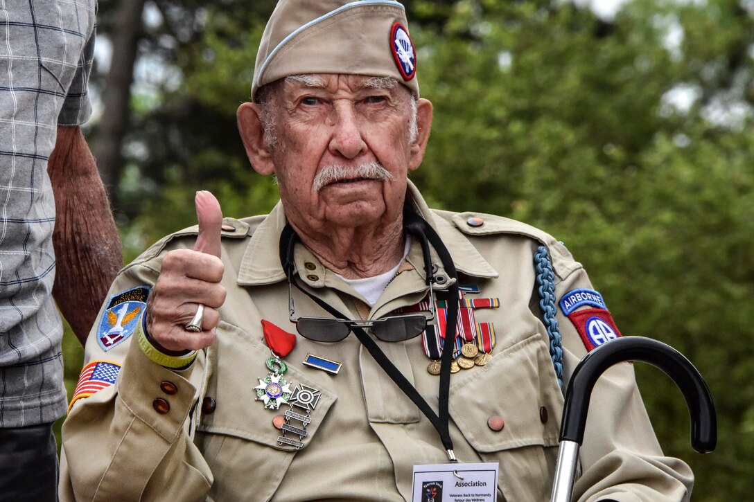 A veteran visits and attends a ceremony at the Normandy American Cemetery in France.