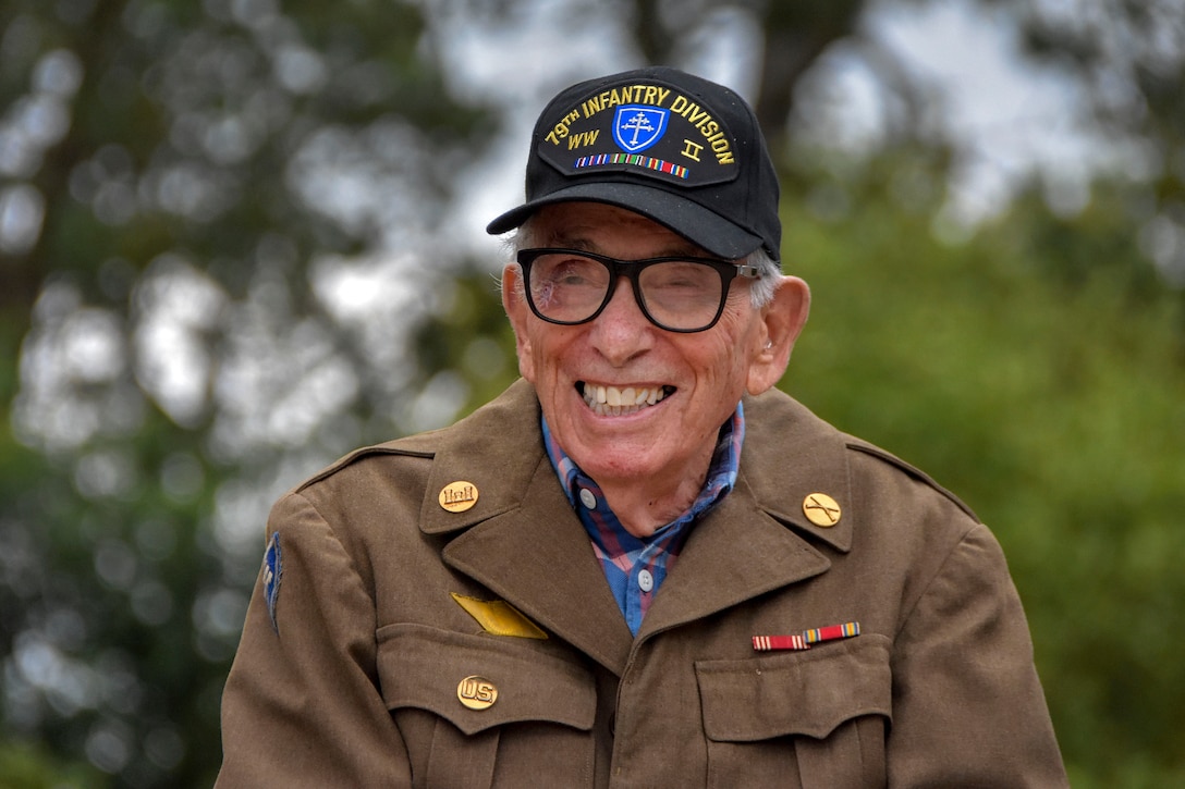 A World War II veteran smiles following a wreath laying ceremony at the Normandy American Cemetery and Memorial in Colleville-sur-Mer, France.