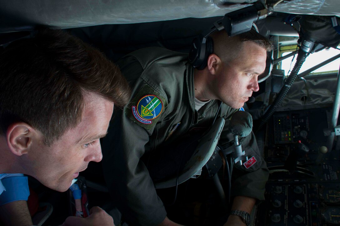 Dan Jovic with KTAL News and Staff Sgt. Patrick Bartosavage, 18th Air Refueling Squadron boom operator, stare through the observation window of a KC-135 Stratotanker after taking off from Barksdale Air Force Base, Louisiana, May 30, 2018.  Jovic and 29 other civic leaders from the Greater Shreveport/Bossier City area took part in a tour to Niagara Falls Air Reserve Station, New York to learn about different aspects of the Air Force mission.  These tours are designed to promote understanding of the military and introduce civilian leaders to other military units they may not otherwise see. (U.S. Air Force photo by Master Sgt. Ted Daigle/released)