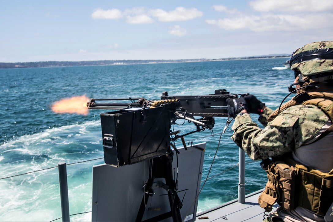 A sailor fires the .50-caliber machine gun.