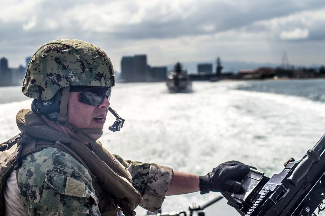 A sailor mans a machine gun aboard a Mark VI patrol boat.