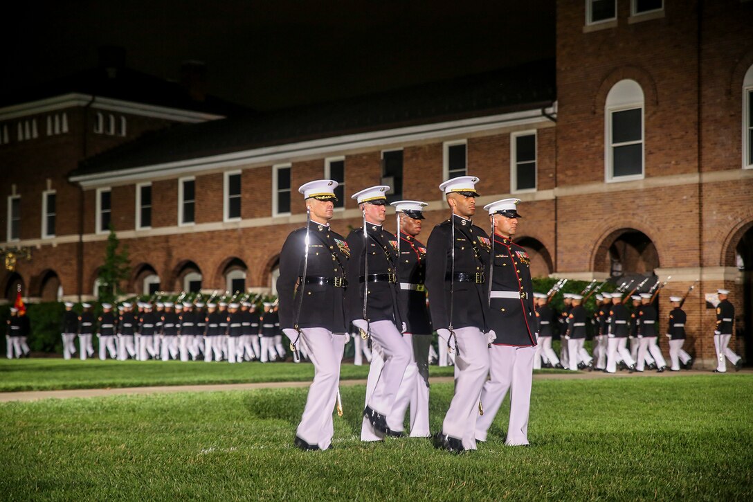 The Marine Barracks Washington parade marching staff marches across the parade deck during the Friday Evening Parade at the Barracks, June 1, 2018.