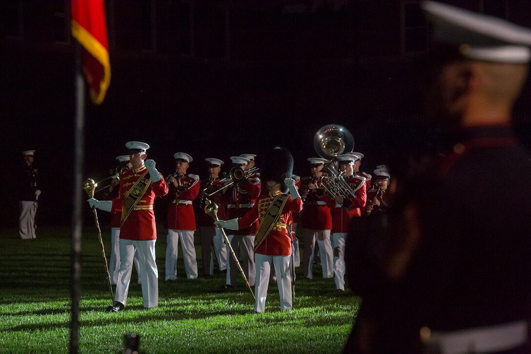 Gunnery Sgt. Joshua Dannemiller, assistant drum major, “The Commandant’s Own” U.S. Marine Drum & Bugle Corps, and Gunnery Sgt. Stacie Crowther, assistant drum major, “The President’s Own” U.S. Marine Band, march their units across the parade deck during the Friday Evening Parade at Marine Barracks Washington, June 1, 2018. The hosting official for the parade was Lt. Gen. Rex McMillian, commanding general, Marine Forces Reserve and Marine Forces North, and the guest of honor was retired Lt. Gen. Robert M. Shea, chairman of Marine Toys for Tots Foundation Board of Directors and president and CEO of the Armed Forces Communications and Electronics Association. (Official Marine Corps photo by Sgt. Robert Knapp/Released)