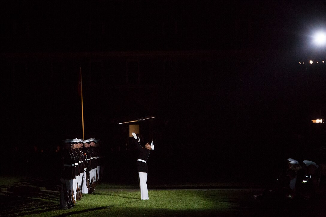 Corporal Christopher Ochoa, rifle inspector, U.S. Marine Corps Silent Drill Platoon, executes a precision rifle toss during the Friday Evening Parade at Marine Barracks Washington, June 1, 2018.