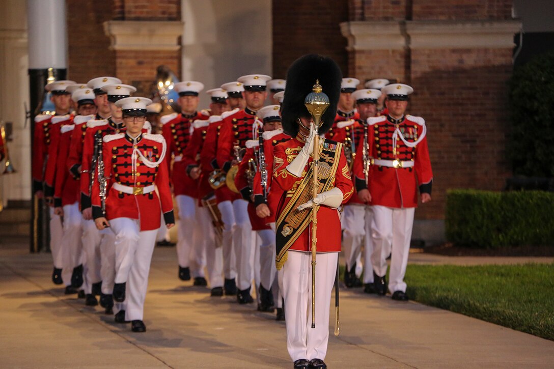 Gunnery Sgt. Stacie Crowther, assistant drum major, “The President’s Own” U.S. Marine Band, marches the band down Center Walk during the Friday Evening Parade at Marine Barracks Washington, June 1, 2018. The hosting official for the parade was Lt. Gen. Rex McMillian, commanding general, Marine Forces Reserve and Marine Forces North, and the guest of honor was retired Lt. Gen. Robert M. Shea, chairman of Marine Toys for Tots Foundation Board of Directors and president and CEO of the Armed Forces Communications and Electronics Association. (Official Marine Corps photo by Cpl. Damon Mclean/Released)