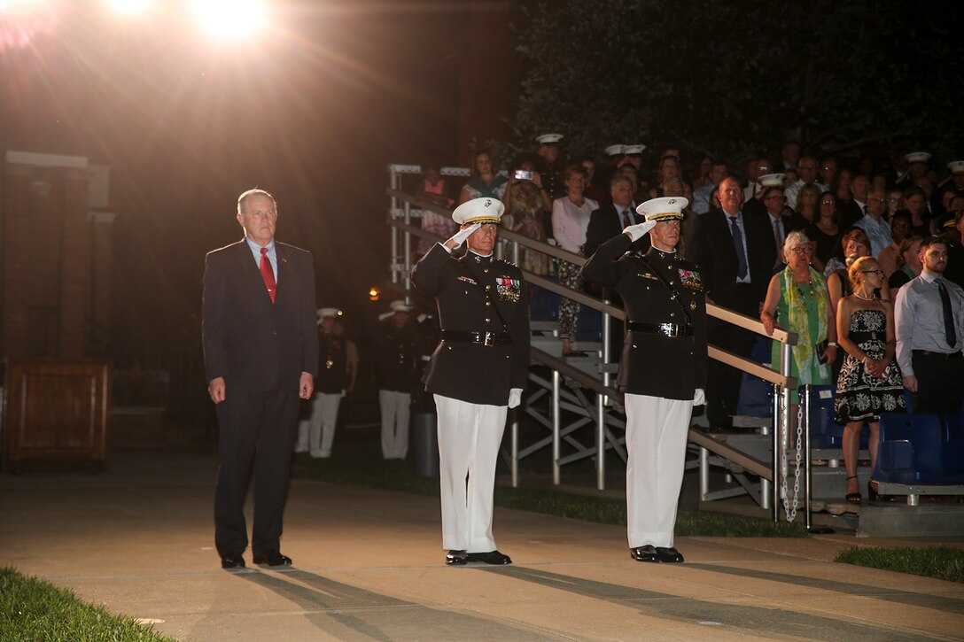The official party for the Friday Evening Parade renders honors during the ceremony at Marine Barracks Washington, June 1, 2018. The hosting official for the parade was Lt. Gen. Rex McMillian, commanding general, Marine Forces Reserve and Marine Forces North, and the guest of honor was retired Lt. Gen. Robert M. Shea, chairman of Marine Toys for Tots Foundation Board of Directors and president and CEO of the Armed Forces Communications and Electronics Association. (Official Marine Corps photo by Cpl. Damon Mclean/Released)