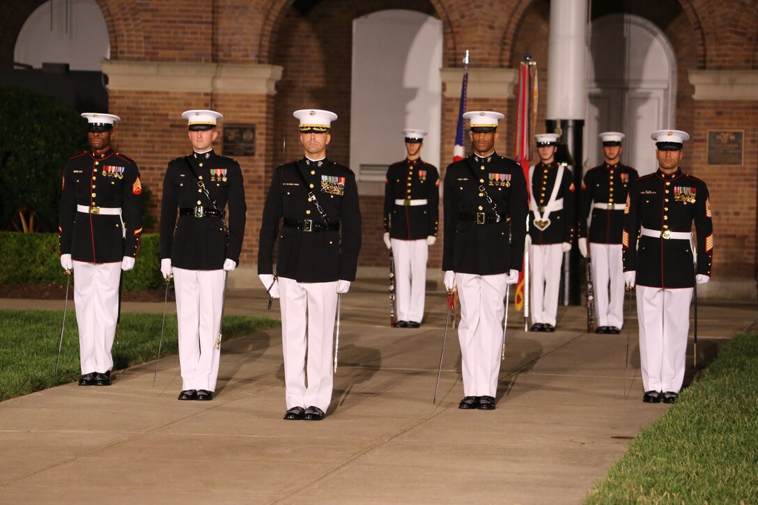 The Marine Barracks Washington parade marching staff stand at a ceremonial position on Center Walk during the Friday Evening Parade at the Barracks, June 1, 2018. The hosting official for the parade was Lt. Gen. Rex McMillian, commanding general, Marine Forces Reserve and Marine Forces North, and the guest of honor was retired Lt. Gen. Robert M. Shea, chairman of Marine Toys for Tots Foundation Board of Directors and president and CEO of the Armed Forces Communications and Electronics Association.