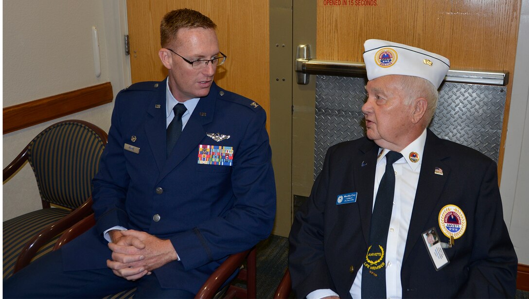 Col. Gregory Krane, 101st Air Operations Group commander, 601st Air Operations Center, speaks with Marlin Coy, AMVETS Department of Florida Representative to the Clifford Chester Sims State Veterans’ Nursing Home, May 28, prior to  Krane’s Memorial Day commemoration remarks there. During his remarks, Krane talked about the residents’ invaluable sacrifice to service, and then stayed after to visit with the residents and personally extend his thanks to them. (Air Force Photo by Mary McHale)