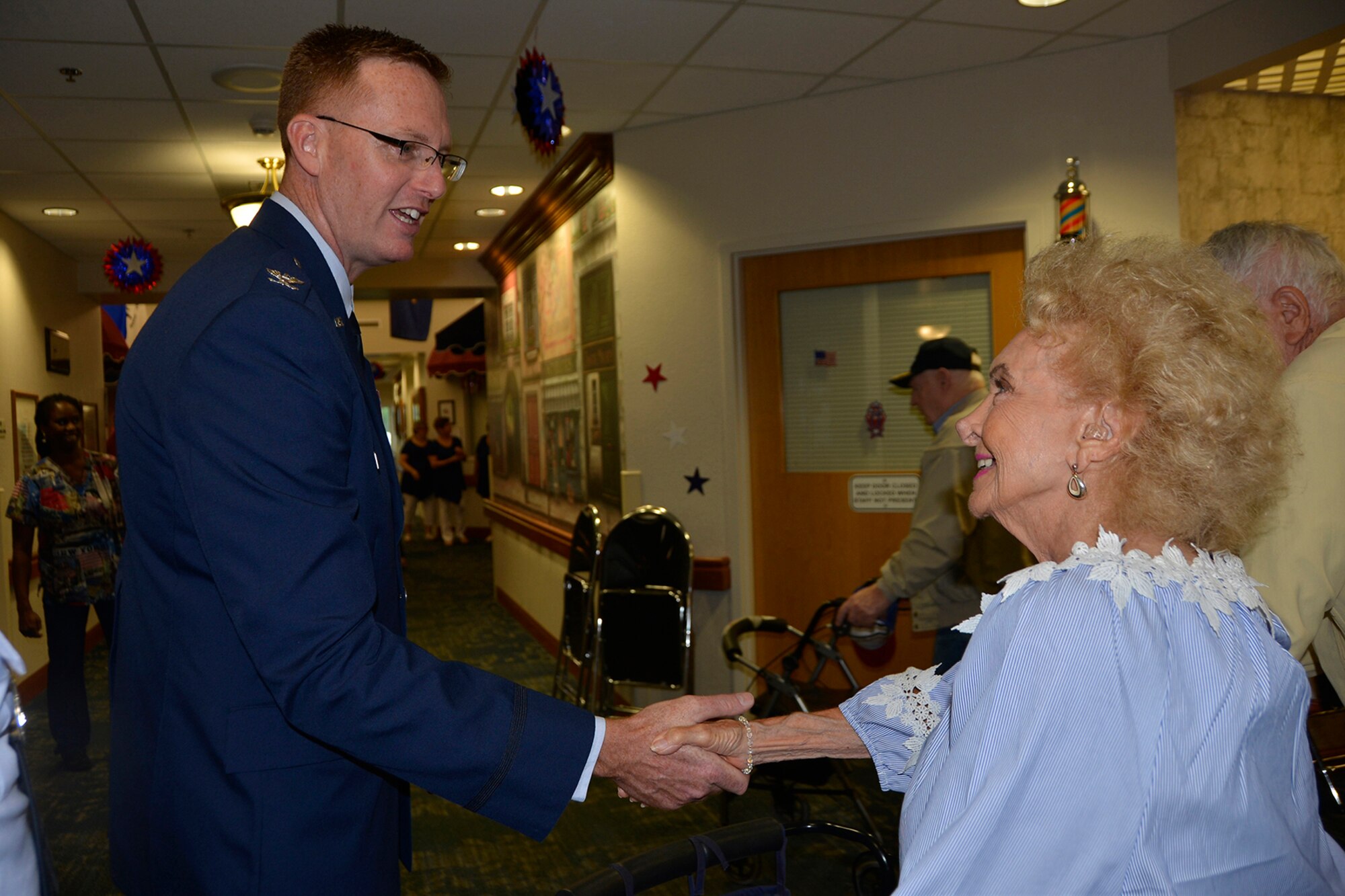 Col. Gregory Krane, 101st Air Operations Group commander, 601st Air Operations Center, greets Maxine Mann, resident of the Clifford Chester Sims State Veterans’ Nursing Home, May 28, following his Memorial Day commemoration remarks there. During his remarks, Krane talked about the residents’ invaluable sacrifice to service, and then stayed after to visit with the residents and personally extend his thanks to them. (Air Force Photo by Mary McHale)