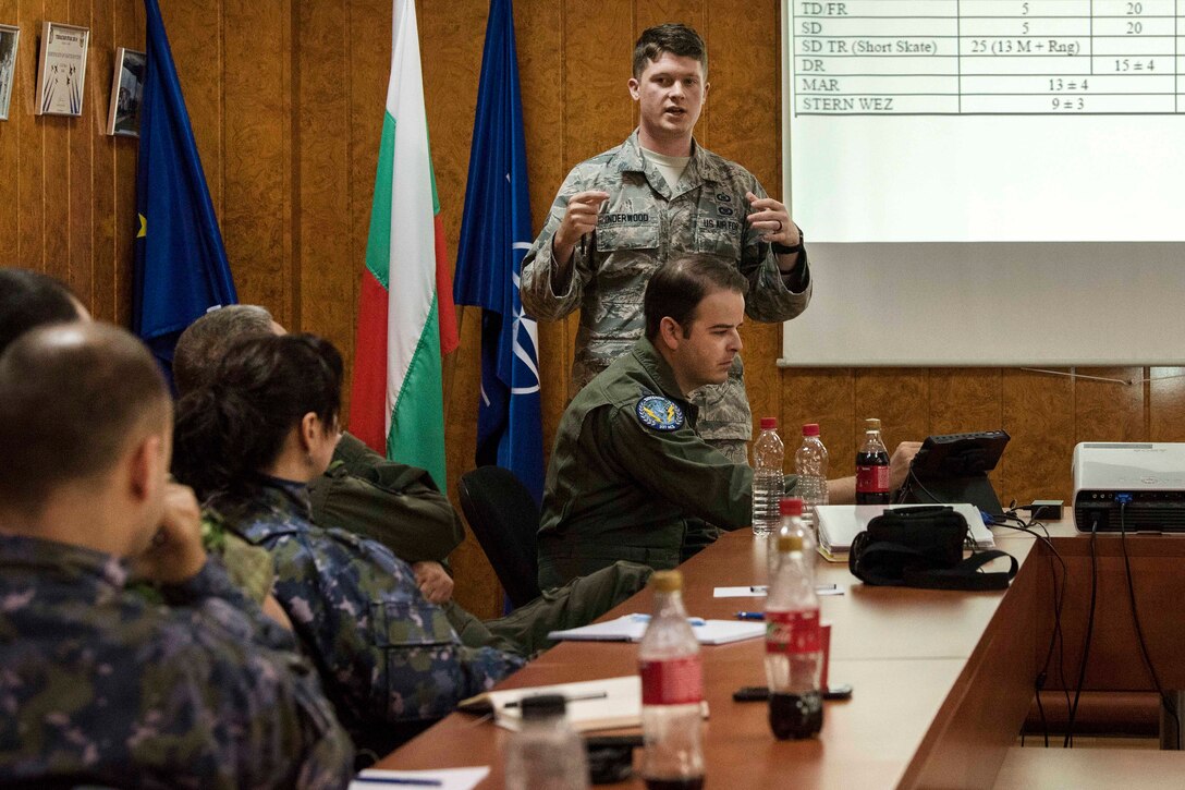 An airman teaches Bulgarian and Romanian air force personnel.