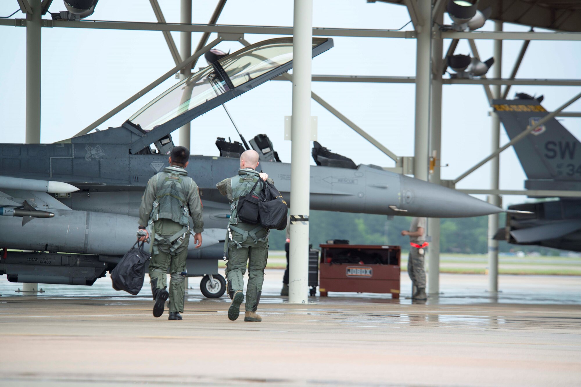 U.S. Air Force Lt. Col. Brandon McBrayer, 20th Operations Group deputy commander, escorts a member of the Philippine Air Force to an F-16DM Fighting Falcon at Shaw Air Force Base, S.C., May 23, 2018.