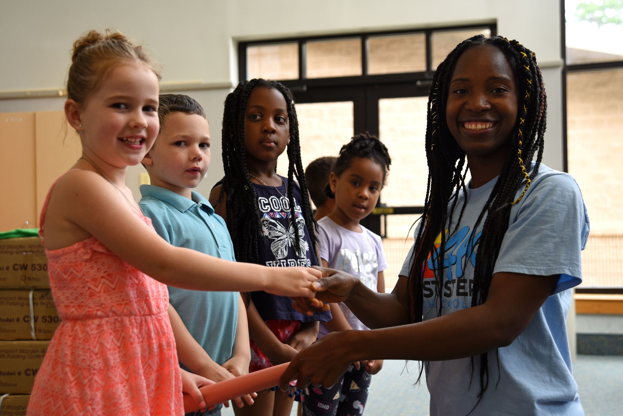 Yassah Kollie, 20th Force Support Squadron child and youth program lead, right, helps her students practice for a graduation ceremony at the Child Development Center at Shaw Air Force Base, S.C., May 31, 2018.