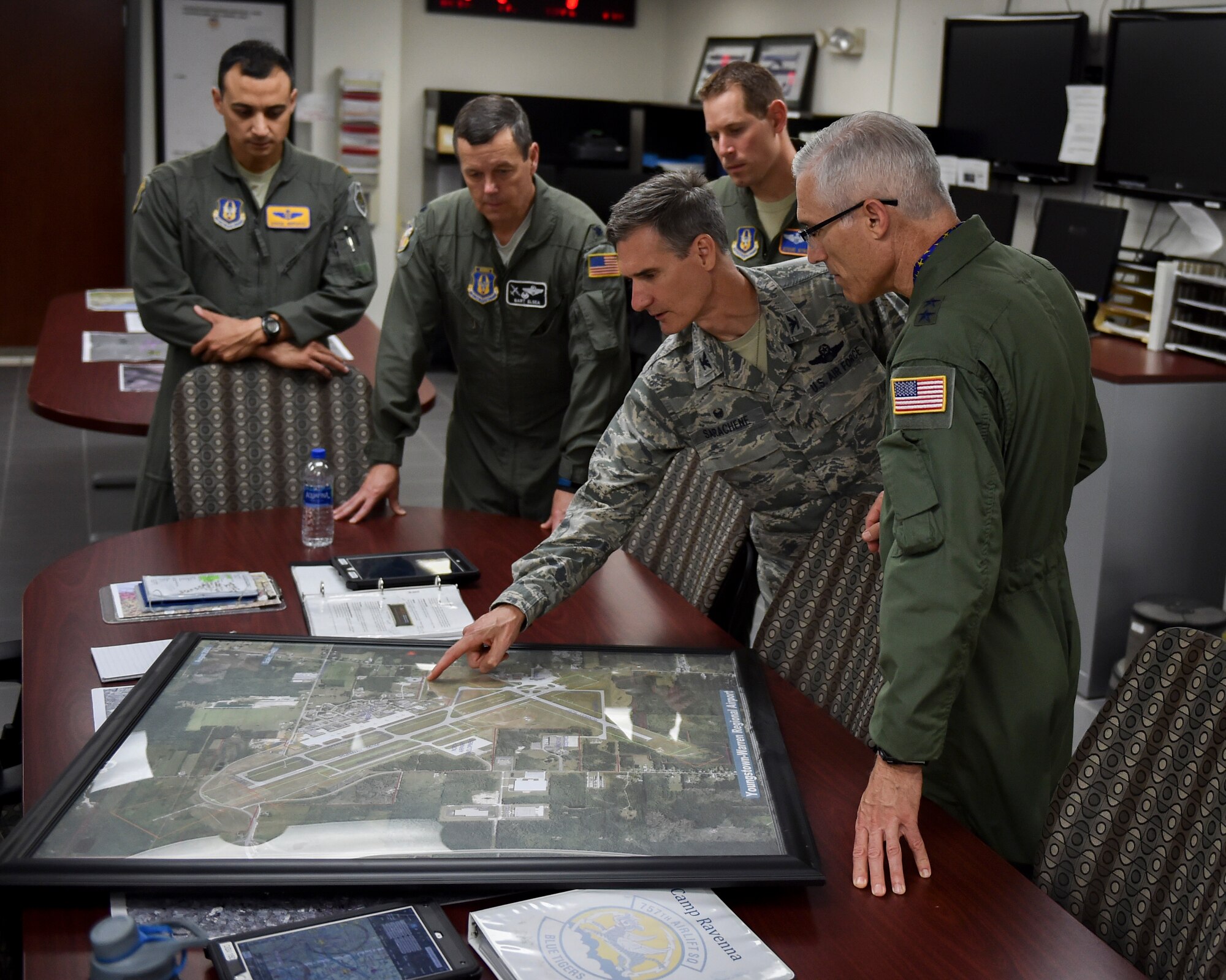 Col. Dan Sarachene, the commander of the 910th AW, briefs Maj. Gen. Craig L. La Fave, the commander of the 22nd Air Force, on the 910th Airlift Wing’s aerial spray mission by in the operations building on Youngstown Air Reserve Station June 2.