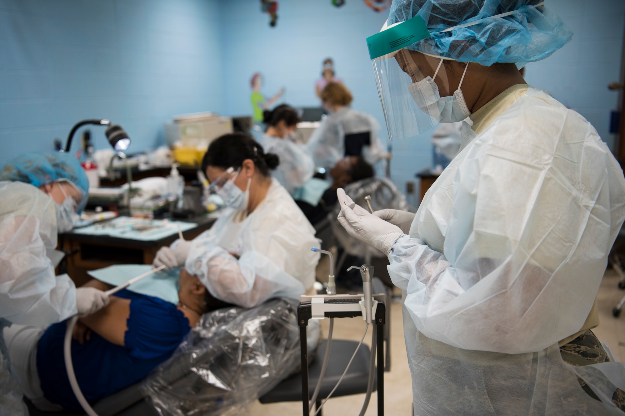 Master Sgt. Tavares Childs, and Air National Guard dental hygienist from the 187th Fighter Wing in Montgomery, Ala., prepares dental equipment during the Alabama Wellness Innovative Readiness Training (IRT) mission June 3, 2018 at Monroe County High School in Monroeville, Ala. Air Guardsmen from Alabama and Wisconsin were part of the joint force participating in the two-week training that provided no-cost health care to the citizens of lower Alabama. (US Air National Guard photo by Staff Sgt. Jared Rand).