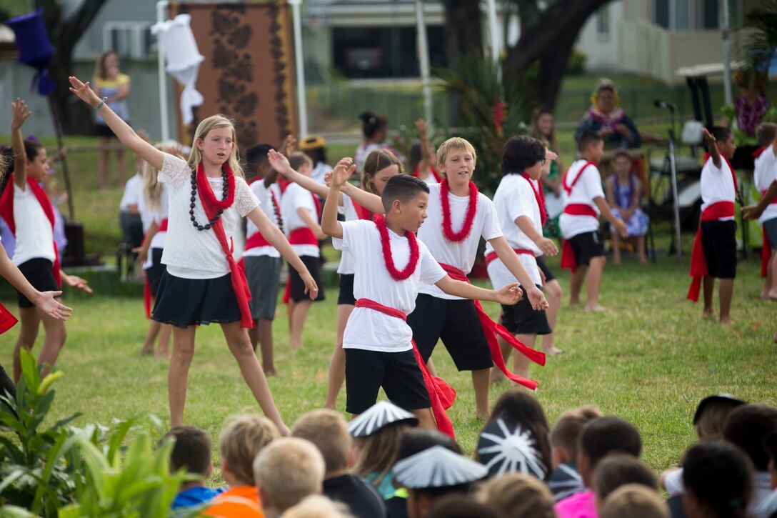 A fourth grader at Mokapu Elementary School, performs a traditional Hawaiian dance during the school’s May Day celebration, Marine Corps Base Hawaii, May 25, 2018. May Day, which is also known as Lei Day, is a Hawaiian public holiday celebrated on May 1st every year, but was postponed due to student testing. Mokapu Elementary School's May Day includes the students performing traditional dances, singing of songs to celebrate Hawaiian culture with families and friends. (U.S. Marine Corps photo by Sgt. Zachary Orr)