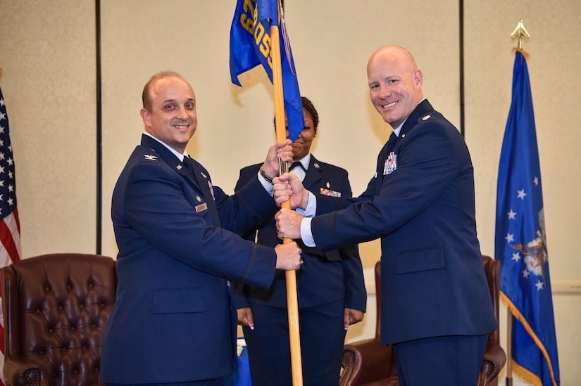 Col. Craig Lambert, left, 628th Medical Group Commander, gives the 628th Medical Support Squadron guidon to Lt. Col. Wade Evans, 628th MDSS commander, during the 628th MDSS assumption of command, June 4, 2018, at Joint Base Charleston, S.C.