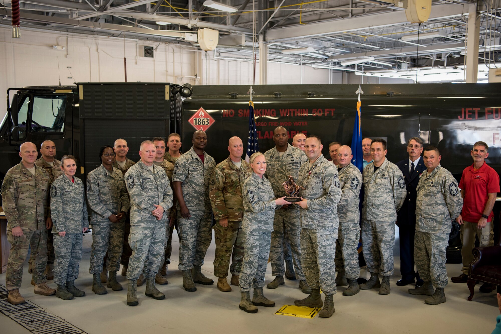 Current and former chief master sergeants present a gift to Chief Master Sgt. Jim Calhoun, 23d Logistics Readiness Squadron superintendent, during Calhoun’s retirement ceremony, June 1, 2017, at Moody Air Force Base, Ga. Calhoun entered the Air Force in August of 1991 and served in numerous positions within fuels management and logistics readiness throughout his career. (U.S. Air Force photo by Senior Airman Daniel Snider)