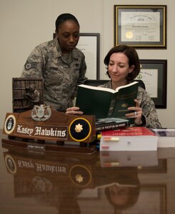 U.S. Air Force Maj. Kasey Hawkins, Air Force Legal Operations Agency Area Defense Council lawyer, and U.S. Air Force Staff Sgt. Michele Stroud, Air Force Legal Operations Agency defense paralegal, read military legal books on Joint Base McGuire-Dix-Lakehurst, N.J., June 4, 2018. The Area Defense Council is a team of two or more Airmen lawyers and paralegals who provide free services to all Airmen with any legal issue or offense. (U.S. Air Force photo by Airman Ariel Owings