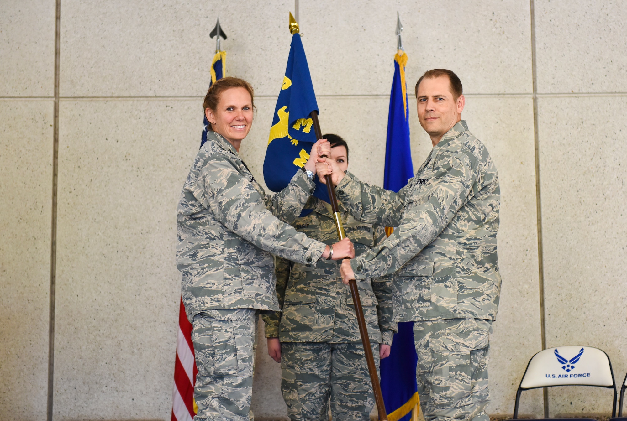 Lt. Col. David Jackson, the new 419th Medical Squadron commander, accepts the squadron flag from Col. Regina Sabric, 419th Fighter Wing commander, during a change of command ceremony