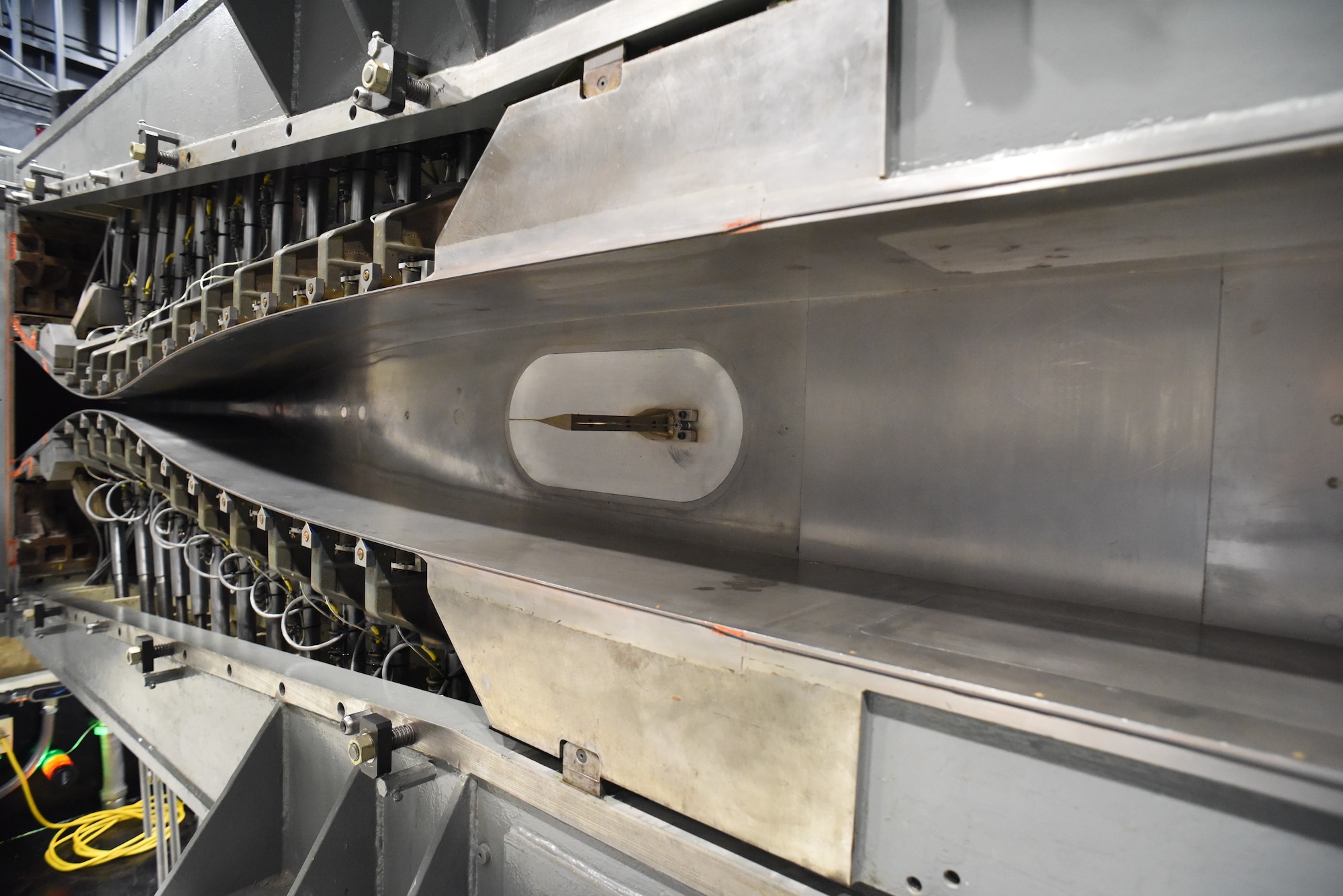 The reactivation of the von Kármán Gas Dynamics Facility Wind Tunnel D is nearing completion after approximately 40 years of dormancy. Here, the Tunnel D flexible plate nozzle contours are adjusted manually using twelve jack screws on the top and bottom surfaces. (Courtesy photo)