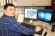 Science and Analytical Engineer Dwain Clark displays his digital 3-D model of the Aeropropulsion Systems Test Facility. Clark completed the model using the AEDC Innovation Grant he received last fall. (U.S. Air Force photo/Bradley Hicks) (This image was manipulated by obscuring badges for security purposes)
