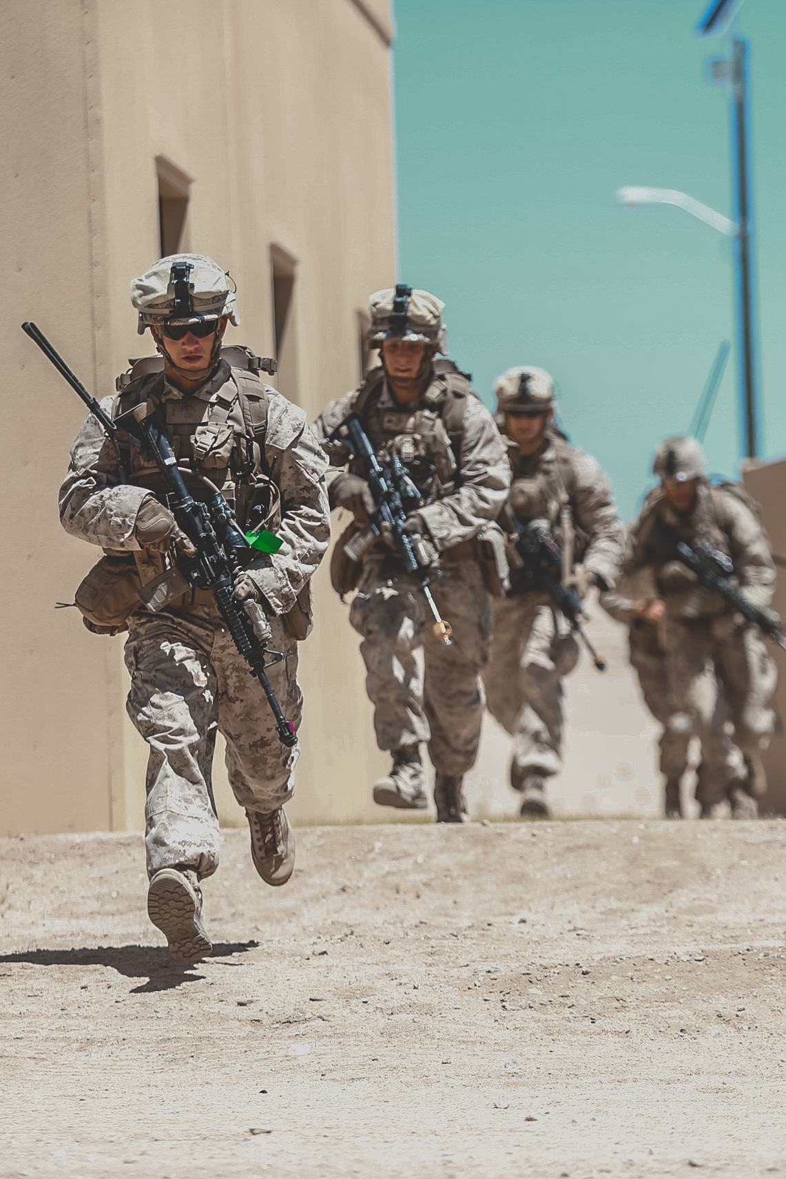 Marines with 3rd Battalion, 2nd Marine Regiment, 2nd Marine Division, sprint across an open area during the FINEX at Range 220 as a part of Integrated Training Exercise 3-18 aboard the Marine Corps Air Ground Combat Center, Twentynine Palms, Calif., May 23, 2018. The purpose of ITX is to create a challenging, realistic training environment that produces combat-ready forces capable of operating as an integrated MAGTF. (U.S. Marine Corps photo by Lance Cpl. William Chockey)