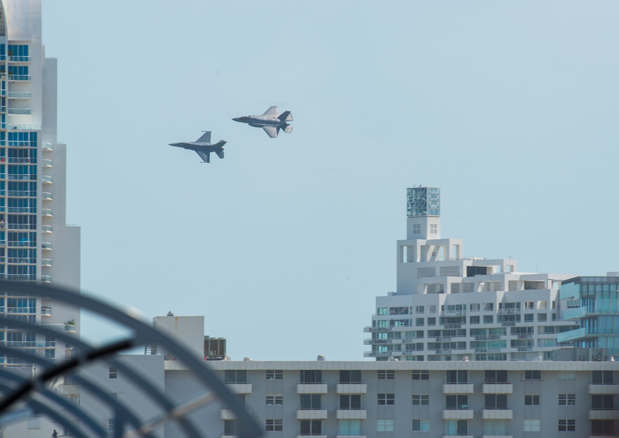 An F-35A Lightning II and F-16 Fighting Falcon fly in formation as part of a heritage flight during the 2018 Hyundai Air and Sea show at Miami Beach, Fla., May 27, 2018. A heritage flight is a dynamic display of the past, present, and future of aviation history in the U.S. Air Force. (U.S. Air Force photo by Airman 1st Class Alexander Cook)