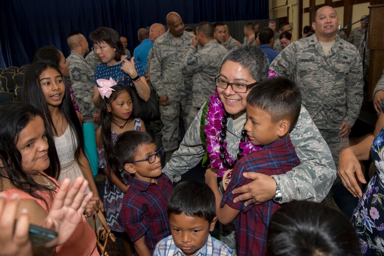 Family and friends present U.S. Air Force Lt. Col. Carla Lugo, 44th Aerial Port Squadron commander, with leis, which are given as a sign of respect and celebration, following an assumption of command ceremony at Andersen Air Force Base, Guam, June 2, 2018.
