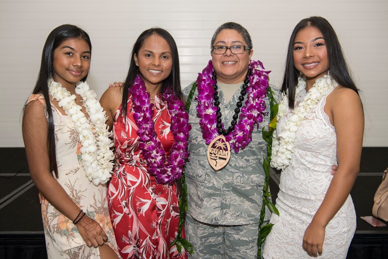 U.S. Air Force Lt. Col. Carla Lugo (center right), 44th Aerial Port Squadron commander, with her family, which include her wife, Tricia Topasna (center left) and their children, Sadie Topasna (left) and Asia Topasna (right), after an assumption of command ceremony at Andersen Air Force Base, Guam, June 2, 2018, where Lugo became the squadron commander.