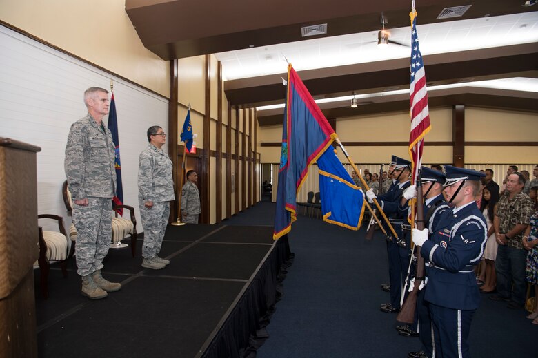 U.S. Air Force Col. Brian McCullagh, 624th Regional Support Group commander, and Lt. Col. Carla Lugo stand at attention for the national anthem during an assumption of command ceremony at Andersen Air Force Base, Guam, June 2, 2018, where Lugo will become the squadron commander.