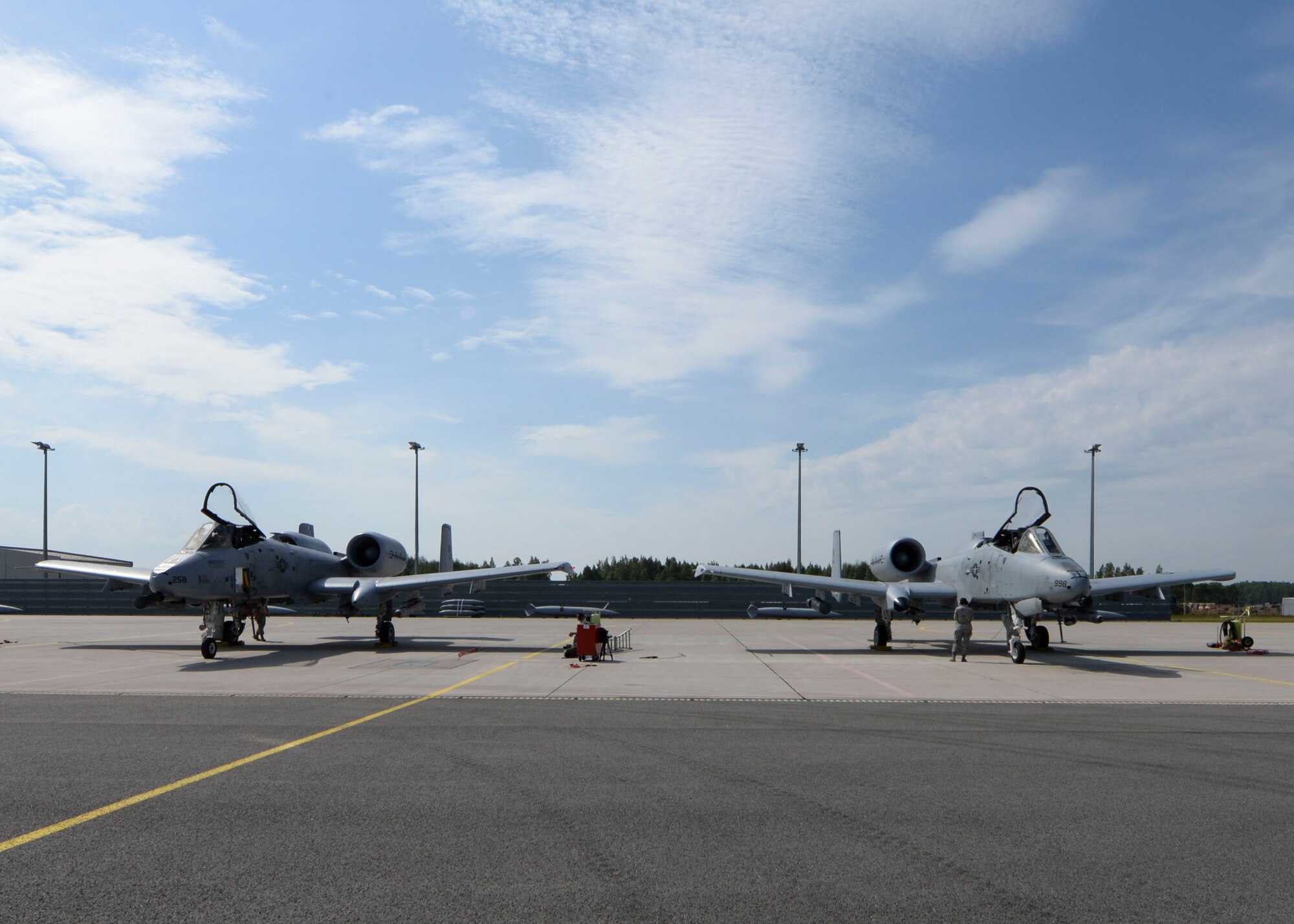 Two A-10 Thunderbolt II aircrafts sit on the flight line at Lielvarde Air Base, Latvia, June 4, 2018. The A-10s were deployed to Europe from the 127th Wing at Selfridge Air National Guard Base, Michigan, to support exercise Saber Strike 18. (U.S. Air Force photo by Staff Sgt. Jimmie D. Pike)