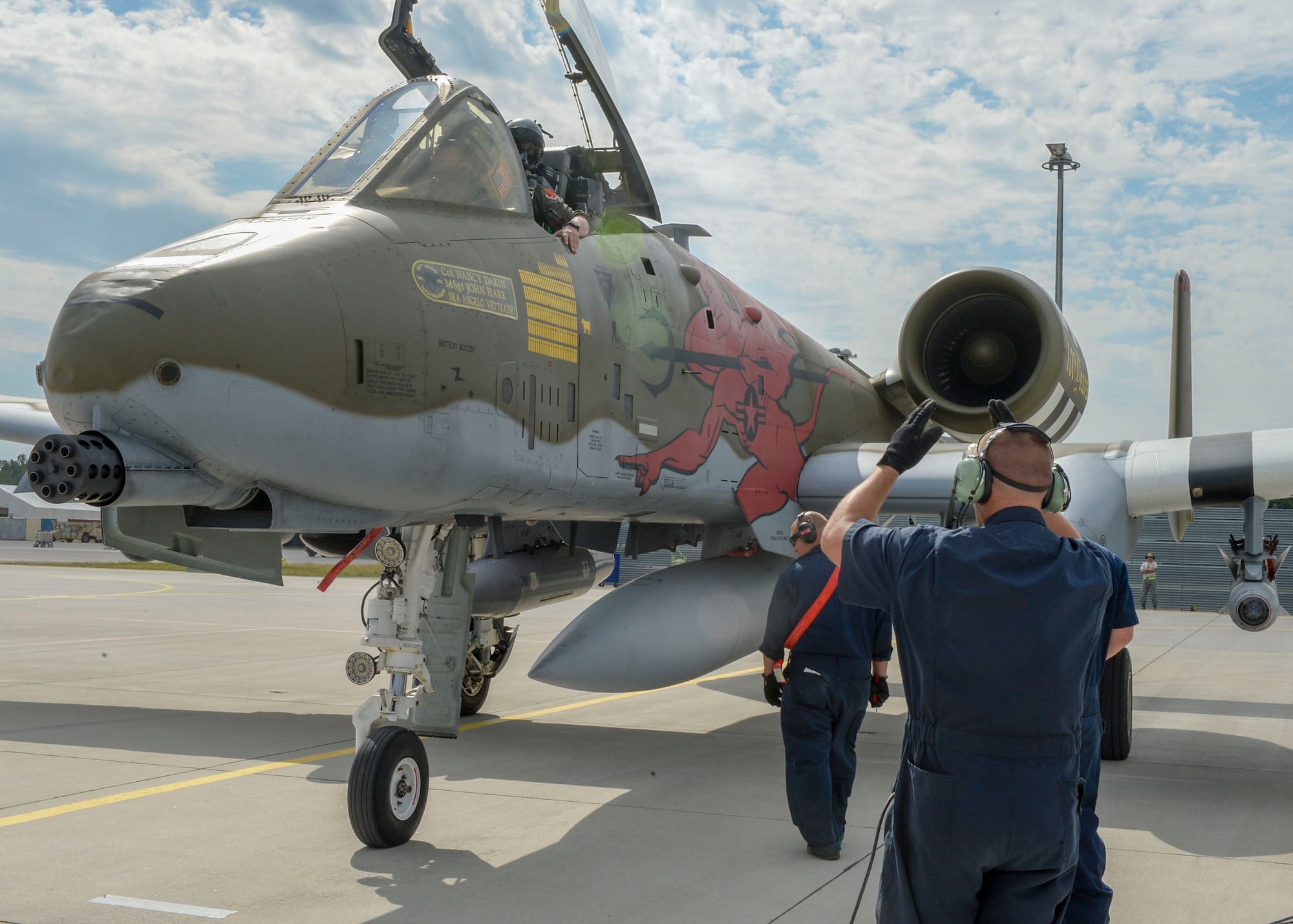 A maintainer directs an A-10 Thunderbolt II pilot to a designated spot on the flight line at Lielvarde Air Base, Latvia, June 4, 2018. A-10s were deployed to Europe from the 127th Wing at Selfridge Air National Guard Base, Michigan, to support exercise Saber Strike 18. While flying, A-10 pilots worked on close air support tactics and communication with Joint Terminal Attack Controllers to combine air and land capabilities for U.S. and partnered nations. (U.S. Air Force photo by Staff Sgt. Jimmie D. Pike)