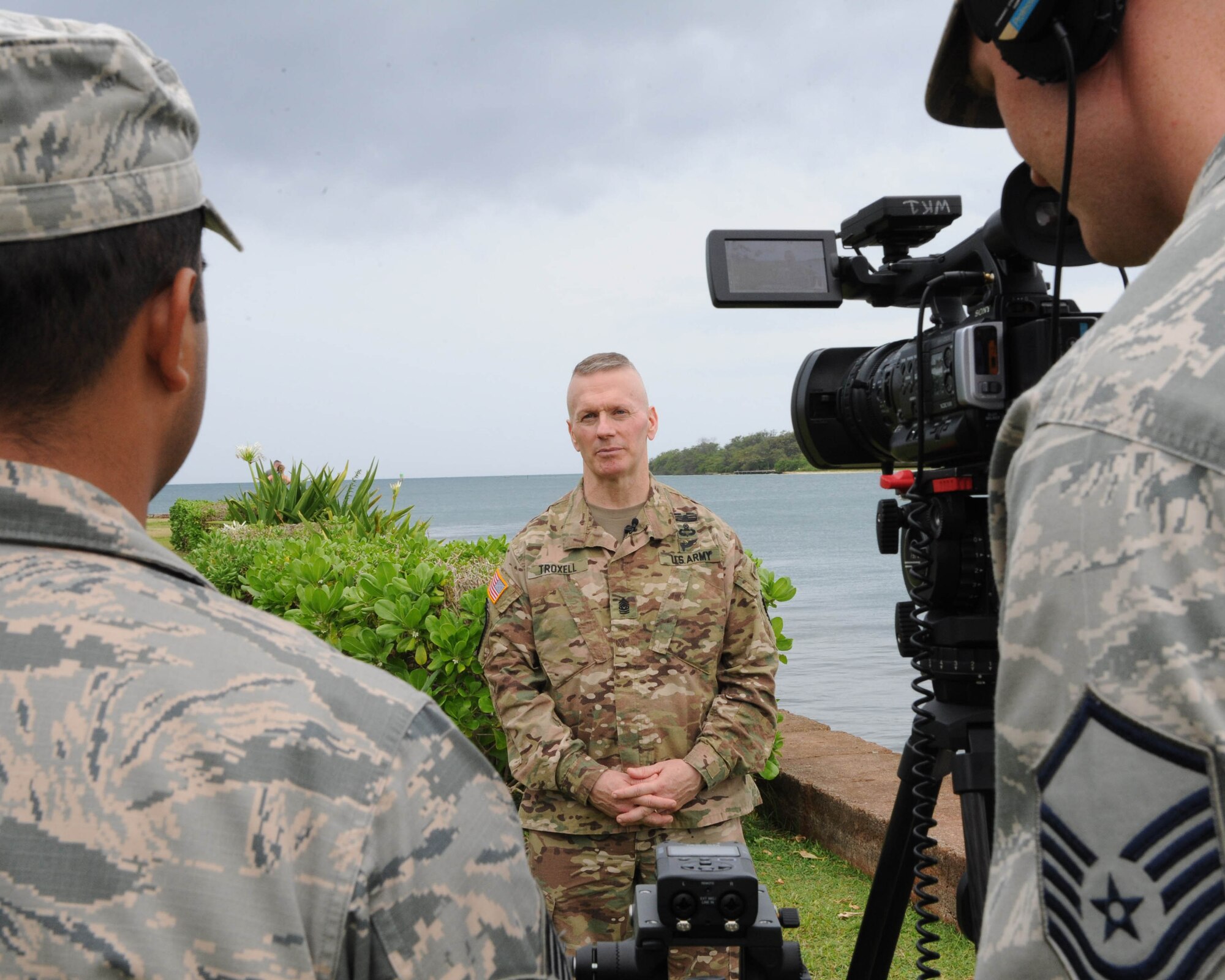 U.S. Air Force Staff Sgt. Daniel Robles (left) and Master Sgt. George Maddon (right), Pacific Air Forces broadcast journalists, interview U.S. Army Command Sgt. Maj. John Wayne Troxell, senior enlisted advisor to the chairman of the Joint Chiefs of Staff, during an enlisted all-call at Joint Base Pearl Harbor-Hickam, Hawaii, May 29, 2018. Troxell is the designated senior noncommissioned officer in the U.S. armed forces and advises the Chairman and the Secretary of Defense on all matters involving joint and combined total force integration, utilization, health of the force, and joint development for enlisted personnel. (U.S. Air Force photo by Master Sgt. Taylor Worley)