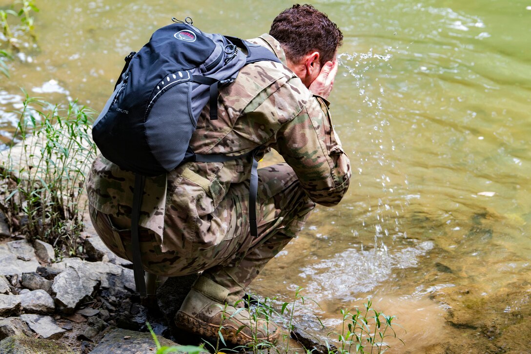 An airman takes a break and cools off in the Little Coal River during training.
