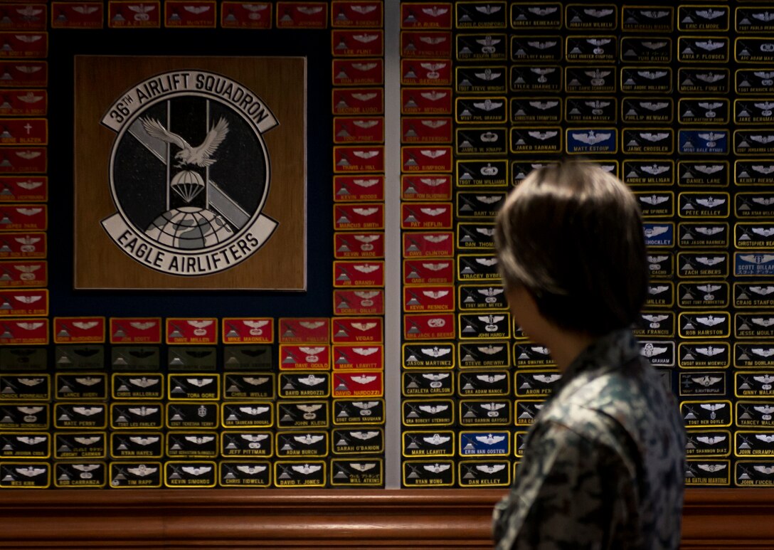A Koku-Jieitai officer looks at a wall covered in nametags