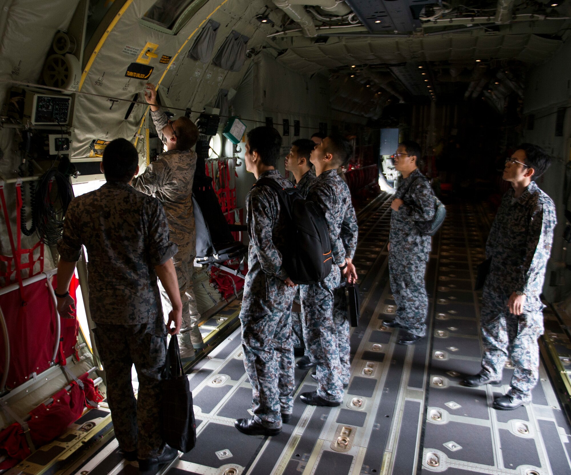 U.S. Air Force Airman 1st Class Joseph Totin, 374th Maintenance Squadron crew chief, shows Koku-Jieitai Airmen the capabilities of a C-130J Super Hercules