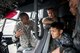 Staff Sgt. Ennis Mayberry, 374th Maintenance Squadron crew chief, talks about the C-130J Super Hercules with Koku-Jieitai maintenance officers