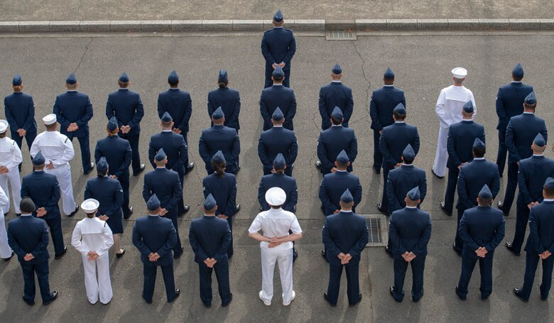 Military personnel stand in formation during a Memorial Day ceremony