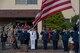 Service members salute during a ceremony for Memorial Day at Yokota Air Base